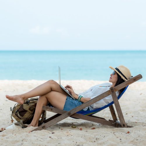 Lifestyle,Freelance,Woman,Using,Laptop,Working,And,Relax,On,The Lifestyle freelance woman using laptop working and relax on the beach. Asian people on trampoline success and together your work pastime and meeting conference on internet in holiday.